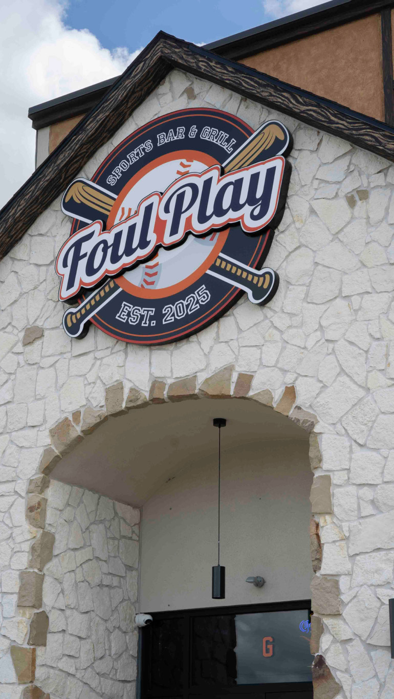The Foul Play Sports Bar & Grill sign mounted on the building